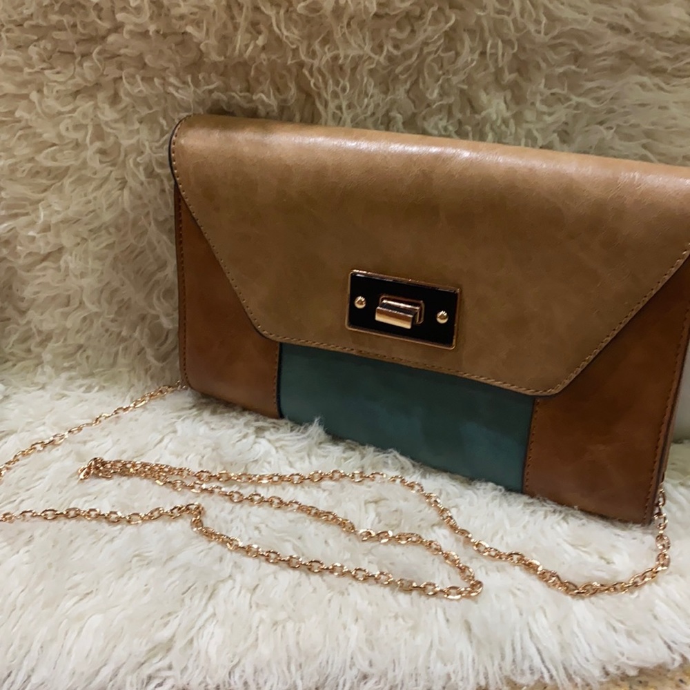 Clutch/crossbody: leather of tan, brown and teal.